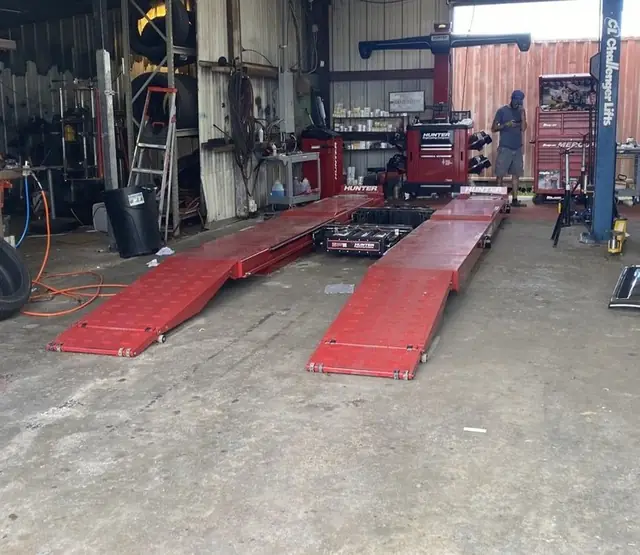 The Hunter drive-on alignment rack on the floor at Bailey's Tire Service in Houma